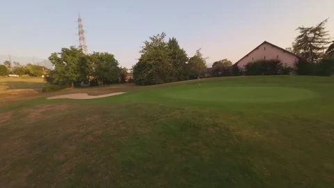 Aerial View of Golf Course at Sunset with Mountain Backdrop Stock Footage 341237713