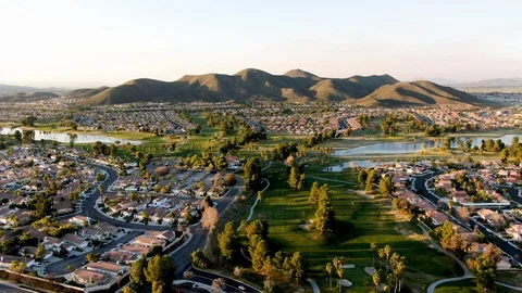 Aerial view of golf course surrounded by town houses and luxury villas during Video stock 124871100