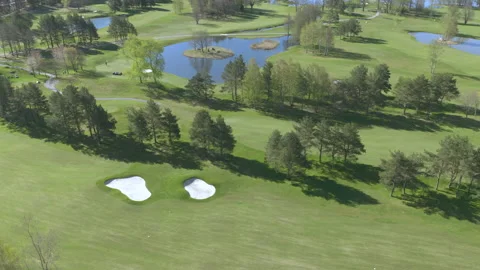 Aerial view of golf course, trees and water Stock Footage 133270554