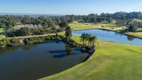 Aerial view of golf course with two water hazard dams, bunkers, and fairways Stock Photos