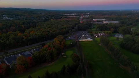 Aerial view of a golf course, winding road, parking lot... Stockbeeldmateriaal 347409504