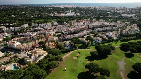 Aerial view of golfers at a golf course in Quarteira, Algarve, Portugal Stock Footage 221786148