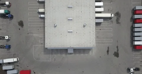 Aerial view of goods warehouse. Logistics center in industrial city zone. Stock Footage 129848321