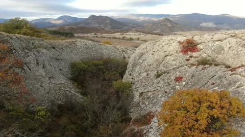 Aerial view of the gorge between the cliffs behind which opens a view of the val Stock-Footage 151140125