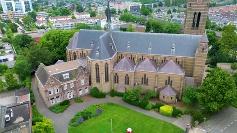Aerial view of a Gothic style stone church with steep roof, arched windows Stock Footage 318063647