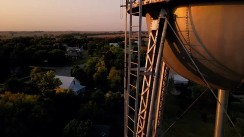 Aerial view of the grain elevator and water tower at dusk Stock Footage 345531463