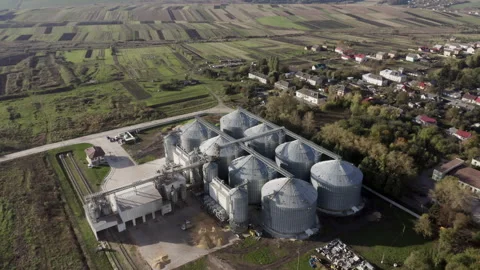 Aerial View of Grain Storage Facility in Ukrainian Village with Surrounding Stock Footage 266751913
