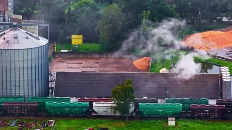 Aerial view of grain storage facility and freight train, Europe. Stock Footage 341483704