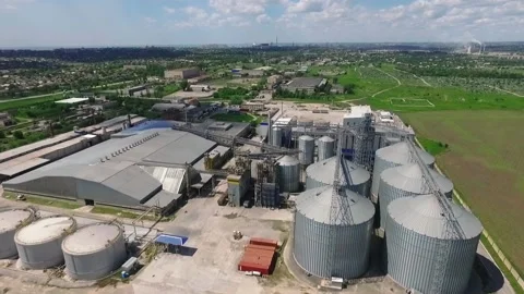 Aerial view Grain, wheat and soybean storage elevators located near the wheat 動画素材 228477065