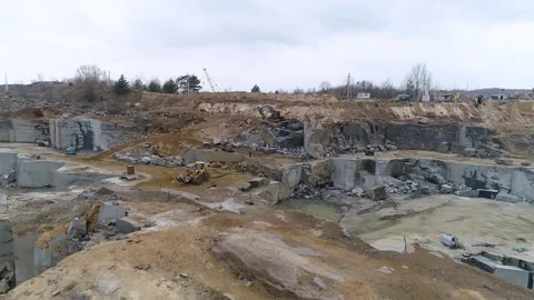 Aerial view of a granite quarry, Big tractor collecting pieces of granite, Stock Footage 162255604