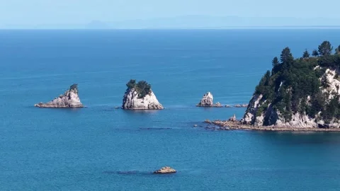Aerial view of granite rock islets and coastal headland in Abel Tasman National Stock Footage 341554670