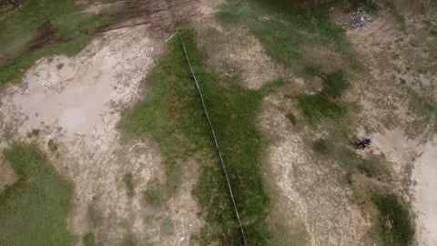 Aerial view of grassy field with sparse vegetation at the Kesongo mud volcano Stock Footage 279754247