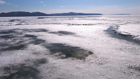 Aerial view of the great river with floating ice floes during sundown. Drifting Stock Footage 91165544