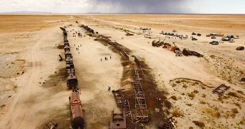 Aerial view of Great Train Graveyard in Uyuni at Bolivian desert Stock Footage 91052689