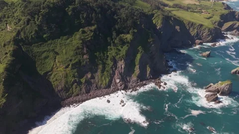 Aerial view of green cliffs dropping to a wild sea Stockbeeldmateriaal 343324601