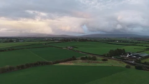 Aerial View of Green Countryside Fields Under Cloudy Sky Stockbeeldmateriaal 333928063