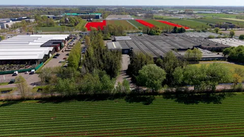 Aerial view of green crop fields, industrial farm buildings, parking area, .. Stock Footage 336814842