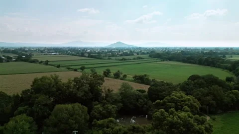 Aerial view of green crop fields, small communities and hills Stock Footage 342089244
