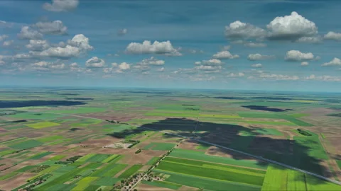 Aerial view of green farm fields with small village houses Stock Footage 345448430