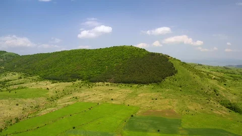 Aerial view of green fields and blue sky Stock Footage 119325229