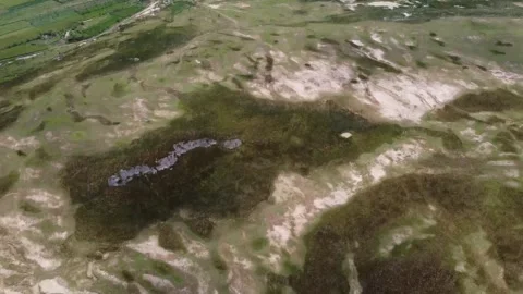 Aerial view of green fields and barren land at The Kesongo mud volcano Stock Footage 279754750
