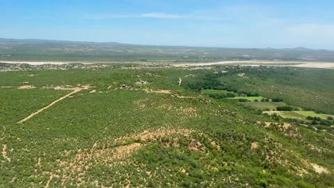 Aerial View of Green Fields and Mountains Stock Footage 284393239
