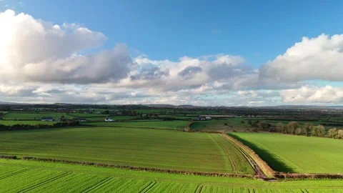 Aerial View of Green Fields and Farm Track Under Dramatic Clouds 库存影片 332738602