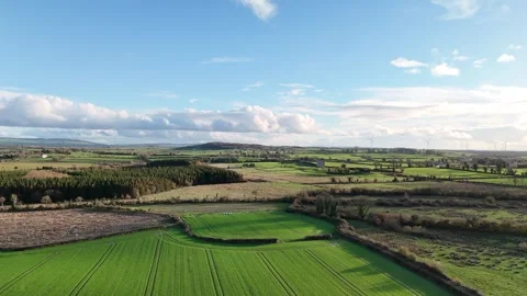 Aerial View of Green Fields and Dramatic Clouds Over Countryside 스톡 동영상 332738615
