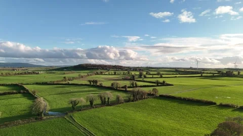 Aerial View of Green Fields and Wind Turbine Under Dramatic Clouds 스톡 동영상 332738737