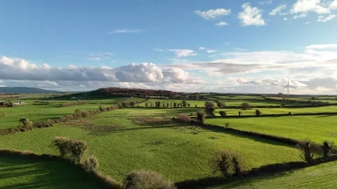 Aerial View of Green Fields and Wind Turbine Under Dramatic Clouds 스톡 동영상 332738753