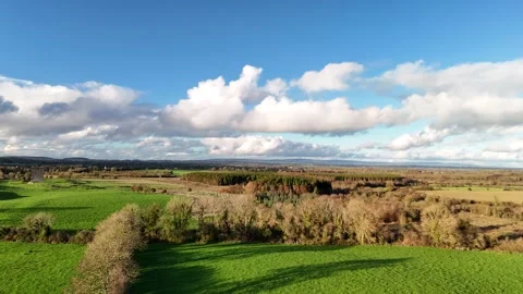 Aerial View of Green Fields and Dramatic Clouds Over Countryside Video stock 332738841