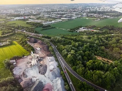 Aerial view of green fields, forest and industrial quarry beside a highway .. Foto stock