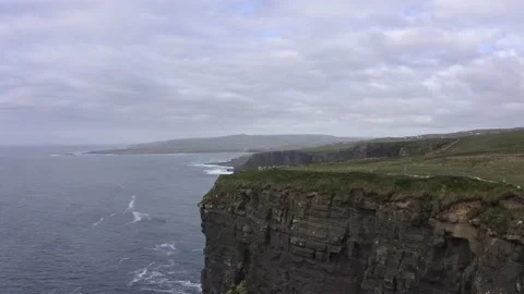 Aerial view of Green fields, high cliffs meadows aerial: road, no cars driving Видео 188688858