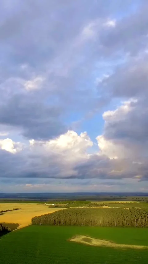 Aerial view of green fields under dramatic clouds Stock Footage 334169208