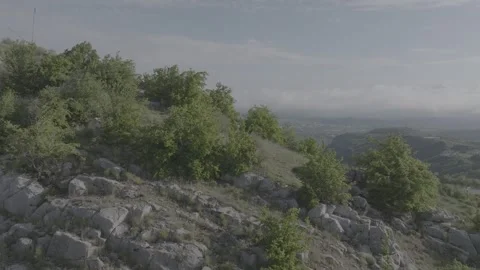 Aerial View of Green Mountain and Distant City Landscape Under Sky Stock Footage 341968992