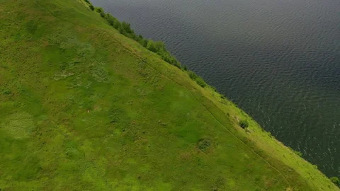 Aerial view of green mountain side near the river Stock Footage 160222085
