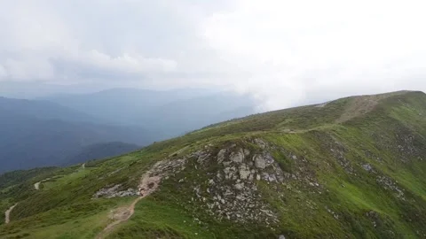 Aerial view of green mountains  on a background of blue sky Stock Footage 148138034