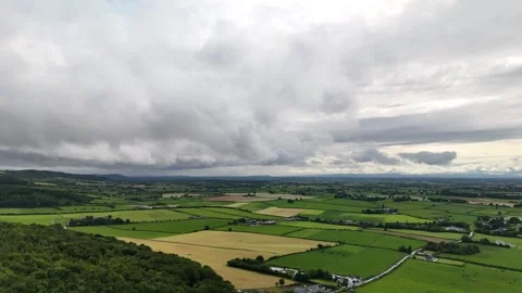 Aerial View of Green Rural Fields Under Cloudy Sky in 4K Stock-Footage 333336657