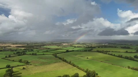 Aerial View of Green Rural Fields Under Cloudy Sky in 4K Stock Footage 333337447