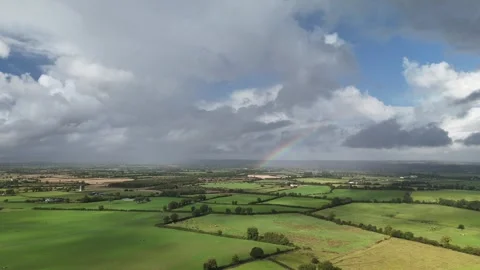 Aerial View of Green Rural Fields Under Cloudy Sky in 4K 库存影片 333337459