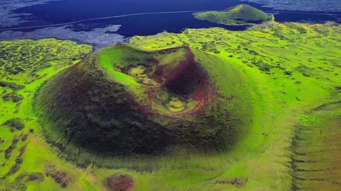 Aerial View of a Green Volcano Surrounded by Lush Landscape Stock-Footage 341645573