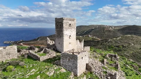 Aerial view of Grigoraki Tower and surrounding stone buildings at sunset in Mani Video stock 301451682