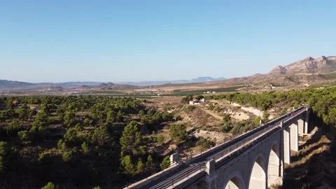 Aerial view of a group of cyclists on a high narrow bridge Video stock 138862040