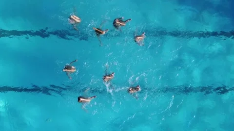 Aerial view of group synchronized swimmers performance with legs Stock Footage 170480680