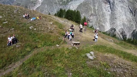 Aerial view - group of trekkers rest on a alpine path Stock Footage 137394098