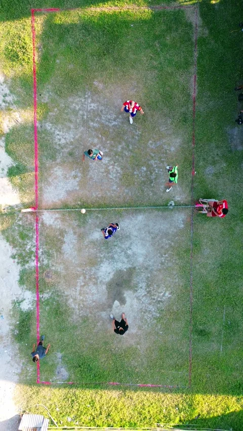 Aerial view of group of young men are playing takraw in the afternoon Stock Footage 297619853