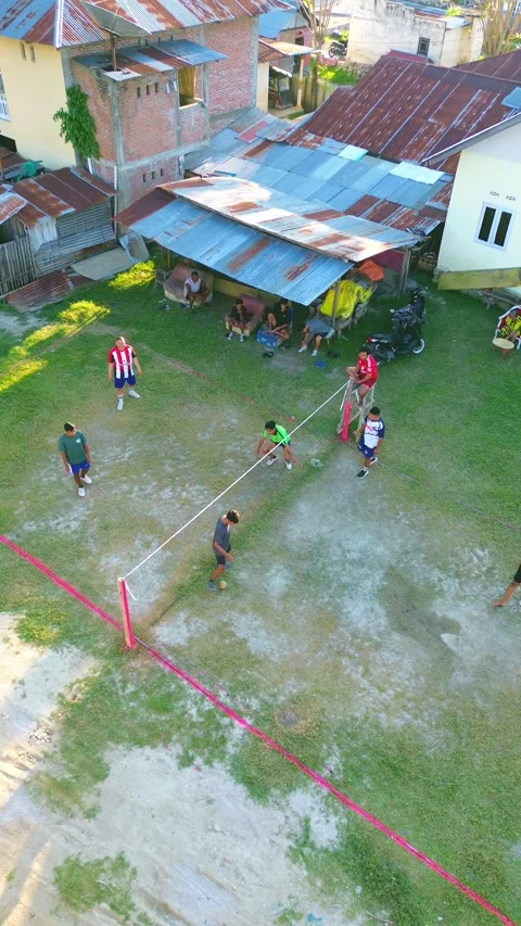Aerial view of group of young men are playing takraw in the afternoon Stock Footage 297622460