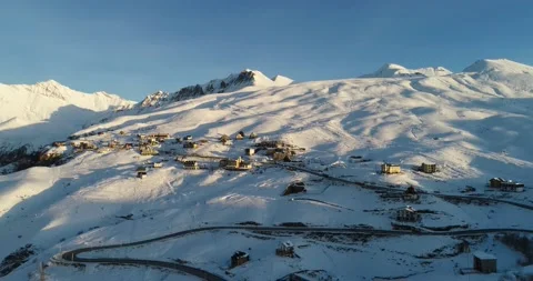 Aerial view of Gudauri ski resort surrounded by Snow covered beautiful caucasus  Stock Footage 147364458