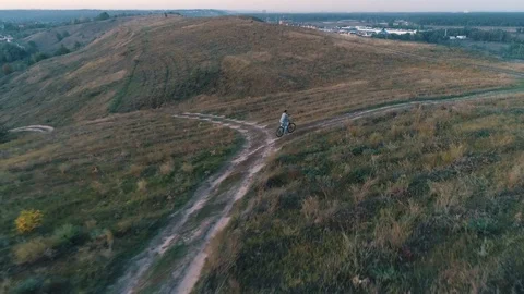 Aerial view of guy rides a bicycle Stock Footage 130157195
