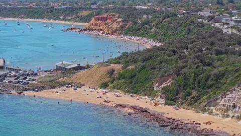 Aerial View of Half Moon Bay Beach and Red Bluff Cliffs in Black Rock Stock Footage 327889296
